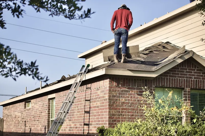 Professional roofer working on a residential roof in Saddle Club Estates